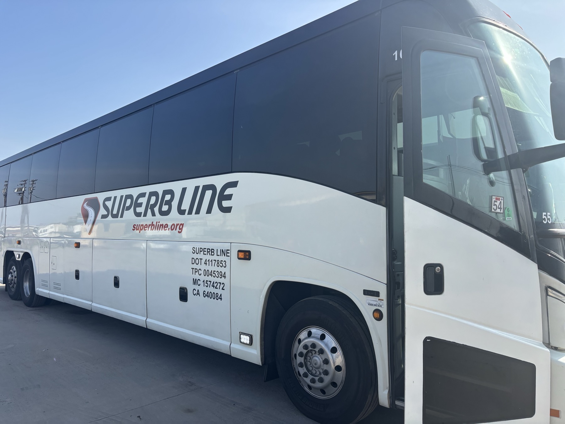 Superb Line full-size charter bus with the passenger door open
